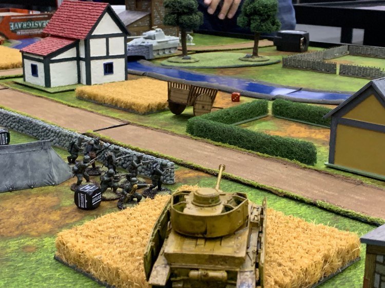 A miniature Panzer IV overlooks a road.